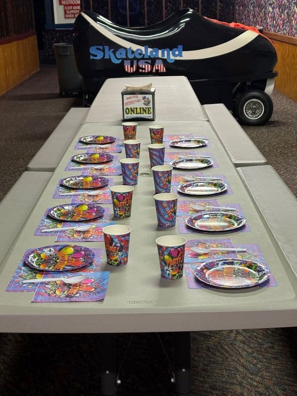 Birthday party table set up in a party area at Skateland